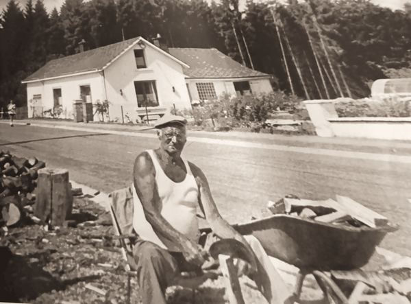 Marcel Watelet devant son tas de bois.